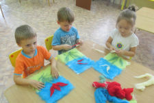 Дети рисуют цветы шерстью.